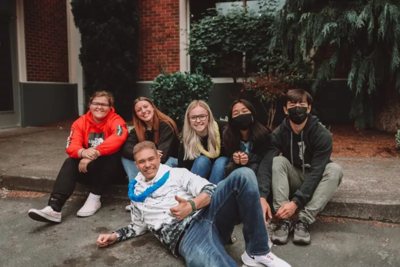 youth_sitting_on_sidewalk